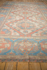 Wide border on distressed Soumac carpet with floral cartouches and pinwheel designs.