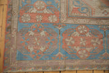 Distressed Soumac rug detail: blue, coral, ivory floral cartouches and geometric patterns.