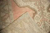Distressed dusty raspberry pile texture and hand-knotted foundation of this vintage Oushak runner.