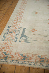 Vintage Distressed Oushak rug, geometric border in copper, dusty navy, and softened ivory.