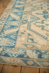 Light blue and ivory distressed Melas rug detail showing geometric border motifs.