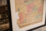 Framed antique Bedford NY map's torn lower edge and aged paper.