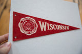 Detail of red felt Wisconsin pennant showing white university seal and lettering.