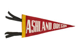 Vintage Ashland Oregon felt flag in red with white lettering, a yellow band, and black ties.