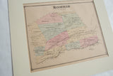 Antique Mansfield NJ map with pastel-colored districts, viewed at an angle in its ivory mat.