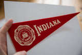 Vintage University of Indiana red felt pennant, cream university seal and lettering.