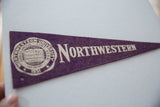 Vintage Northwestern University felt pennant, close-up of purple felt texture and off-white lettering.