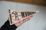 Vintage West Virginia felt pennant showing man with shotgun graphic and black text.