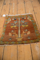 A corner detail showing the pawn design border and polychrome selvage on an antique Tabriz rug.