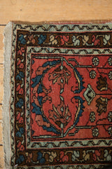 Detailed corner of vintage Lilihan rug with faded raspberry, blue palmettes, and vinery.