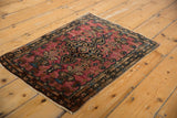 Vintage Farahan Sarouk rug shown from an angle, highlighting its dramatic central medallion.