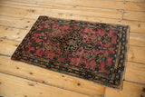 Vintage Farahan Sarouk collector rug with a dramatic geometric medallion on a raspberry red field.