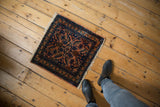 Vintage Lilihan rug corner displaying fine weave, fringe, terracotta, navy, and cobalt floral motifs.