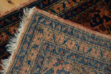 Lilihan rug corner showing fine weave, terracotta selvage, partial fringe, floral motifs.