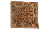 Distressed Farahan Sarouk rug with an intricate floral and vinery pattern in bronze, rose, and blue.