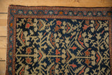 Vintage Farahan Sarouk rug corner, indigo field, blossomed plants, meandering vine border, pile wear.
