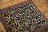 Deep indigo field with serrated blossomed plants, ornate border, and even wear to knot heads.