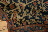 Vintage Persian rug detail: indigo field, beige serrated floral, red-blue border.