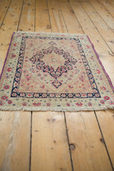 Purple side cord and low, worn pile on an antique hand-knotted Persian Kerman mat.