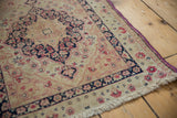 Low pile with visible knot heads and fuchsia purple selvage on an antique Kerman rug.