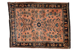 Vintage Persian Mohajeran Sarouk rug with dusty rose sprawling floral field and dark navy border.