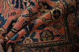 Textured pile of a Vintage Lilihan rug featuring faded rose and indigo floral arabesque patterns.