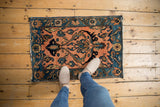 Vintage Lilihan rug corner showcasing pale apricot field, navy border, and boteh floral motifs.