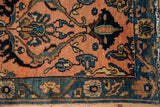 Vintage Lilihan rug detail: apricot field, dramatic navy blossoms, and original side selvage.