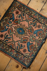 Vintage Lilihan rug corner with dusty rose field, floral vinery border, and intact side selvage.
