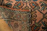 Vintage Lilihan rug's side with madder root selvage, black machine-bound end, and dusty rose pile.