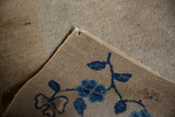 Detail of a corner imperfection on an antique Peking rug, showing the handwoven back.