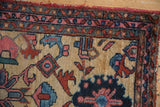 Vintage Lilihan rug detail: ivory field with geometric designs, raspberry, blue, green vine border.
