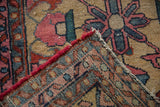 Lilihan rug corner: geometric pile, visible woven foundation, and tattered red side.