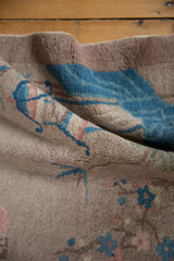 Textured pile of a Vintage Art Deco pictorial rug in dusty mauve and sky blue.
