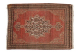 Distressed Persian Senneh rug, terracotta field, Herati medallion, vine and seed borders.