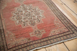 Distressed Senneh rug: abrashed dusty copper field, ivory Herati medallion, and faint foundation.