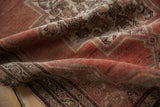Textured pile of a distressed vintage Senneh rug showing copper and ivory Herati design.