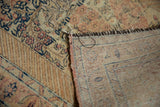 Softly worn pile of a vintage Tabriz rug with exposed foundation and dark machine bound edge.