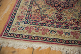 Detail of an antique Kerman's millefleur border, cochineal red side cord, and ivory fringe.