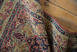 The hand-knotted texture and intact side cord of a circa 1910s Persian Kerman rug.