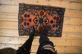 Detail of vintage Persian Lilihan rug, dusty rose field with sapphire blue floral vines.