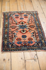 Vintage Lilihan rug's brilliant central floral design, dusty rose, sapphire blue.