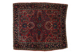 A vintage German Sarouk square rug with dense, allover floral sprays in raspberry red and indigo blue.
