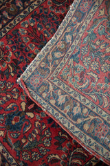 The reverse of a vintage German Sarouk rug, showing the dense hand-knotted weave and intact side cord selvage.