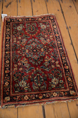Rich floral bouquets, blossoms, and vine border on a vintage Sarouk rug in brick red.