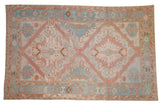 Distressed vintage Soumac carpet, geometric double medallions in dusty rose, powder blue, and ivory.