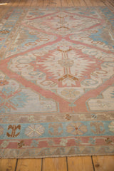 Geometric dusty rose and powder blue patterns with visible abrash on a vintage Soumac rug.