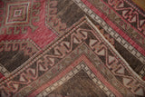 Intact side cord selvage on a distressed Oushak runner with raspberry red and silver geometric borders.