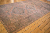 Distressed Soumac carpet border and field with geometric patterns, dusty blush, charcoal brown.