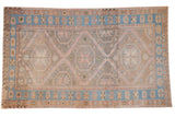 Distressed vintage Soumac carpet with triple geometric medallions, dusty rose, sky blue, and neutral tones.